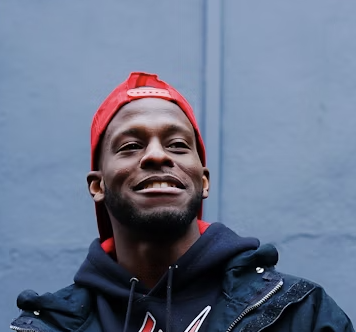Smiling man in red cap